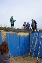 James Farrell, course tutor, talking participants through a container green roof at Organic Roofs HQ