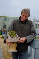 Happy course participant with their green roofed bird box